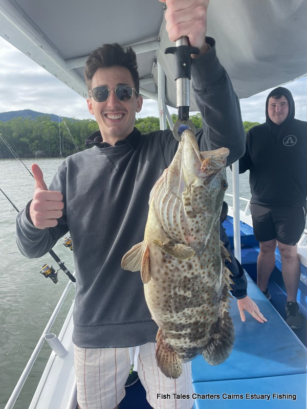 Woody proudly showing us his Goldspotted Estuary Cod while taking a guided fishing charter in Trinity Inlet, Cairns