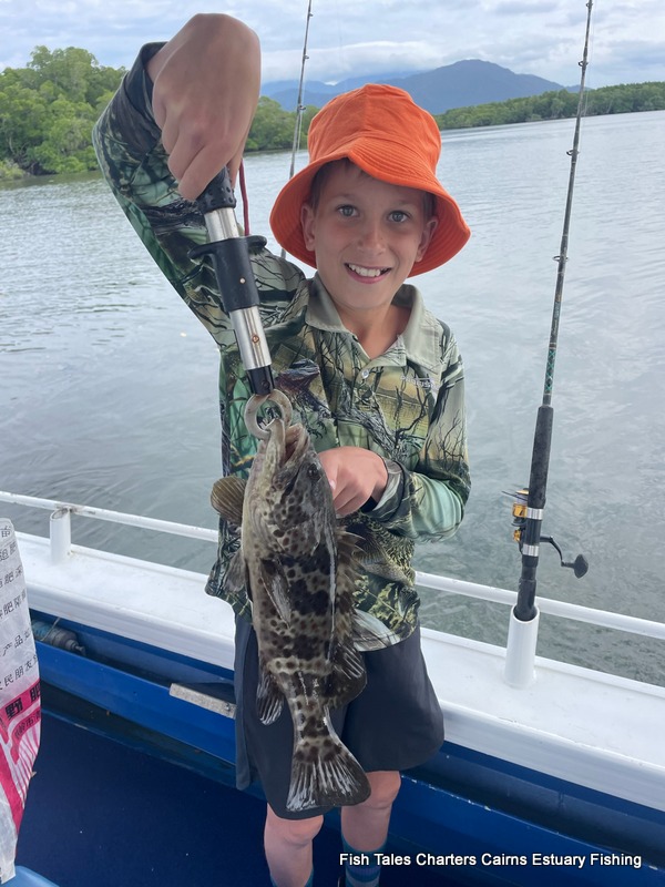 Young Darcy showing us his catch of a Blackspotted Estuary Cod while estuary fishing in Trinity Inlet, Cairns!