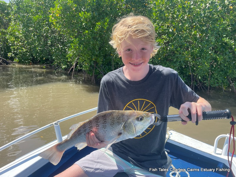 Rocky holding his catch of a Barred Javelin Fish (locally known as a Grunter) while fishing the estuary of Trinity Inlet, Cairns!