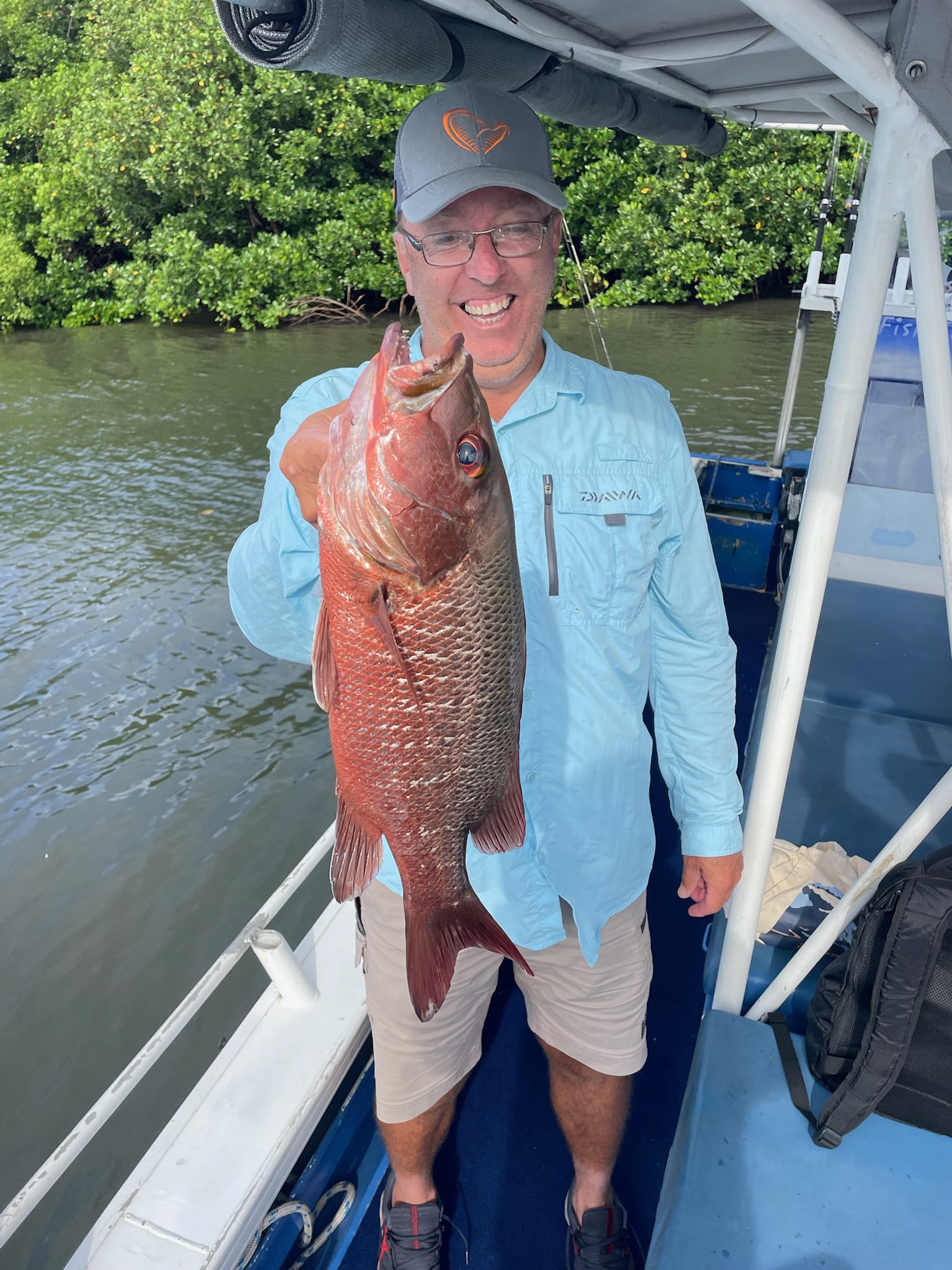 Sebastian is delighted with his catch of a Mangrove Jack while on a estuary fishing charter is Trinity Inlet, Cairns, Far North Queensland