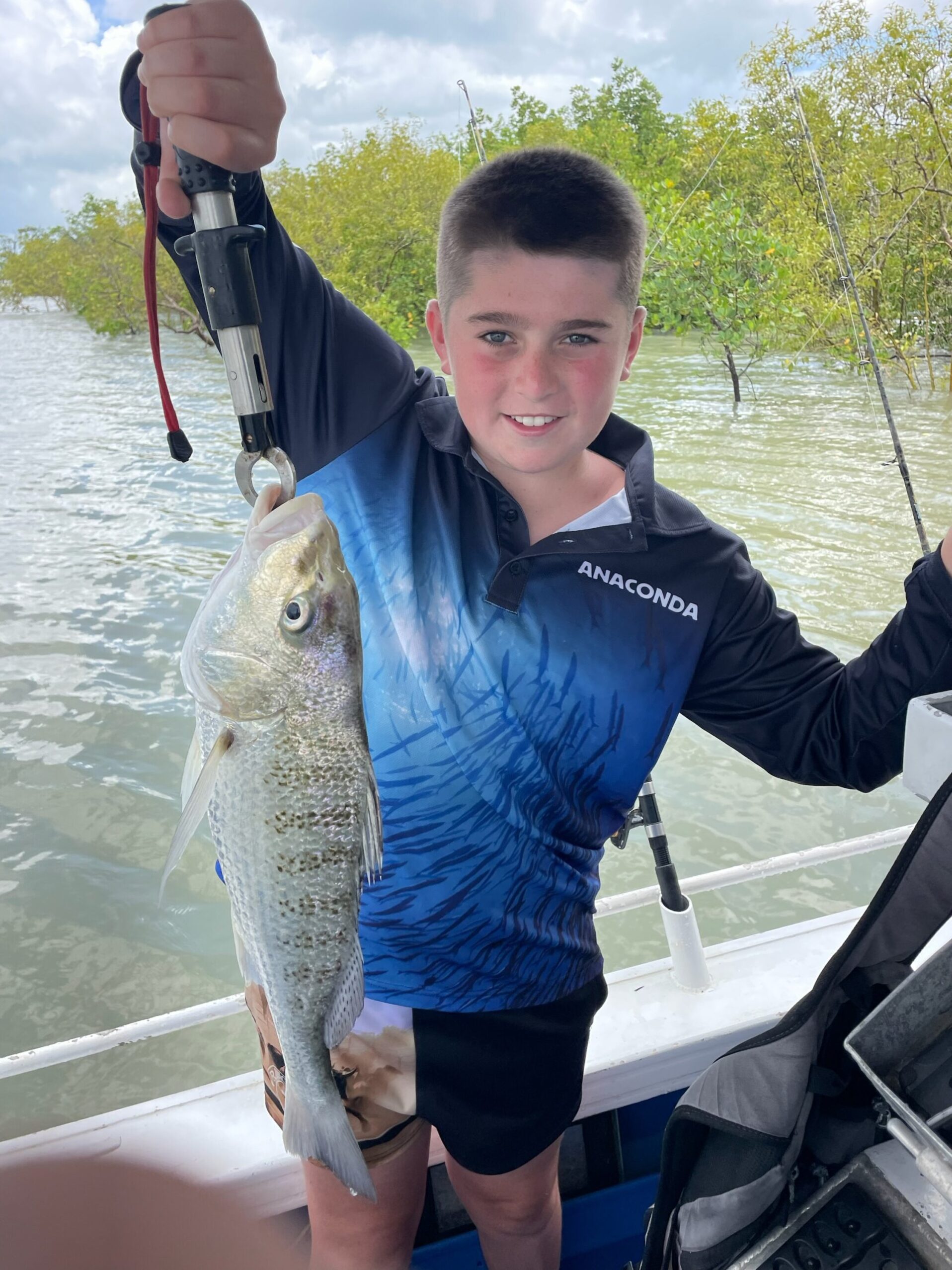Rocky holding his catch of a Barred Javelin Fish (locally known as a Grunter) while fishing the estuary of Trinity Inlet, Cairns!