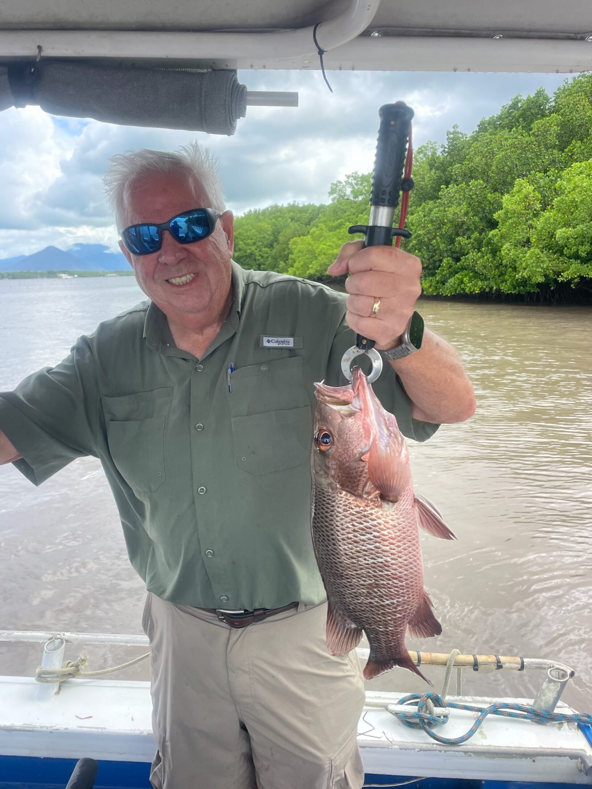 A happy customer showing us his catch of a Mangrove jack while estuary fishing in Trinity Inlet, Cairns!