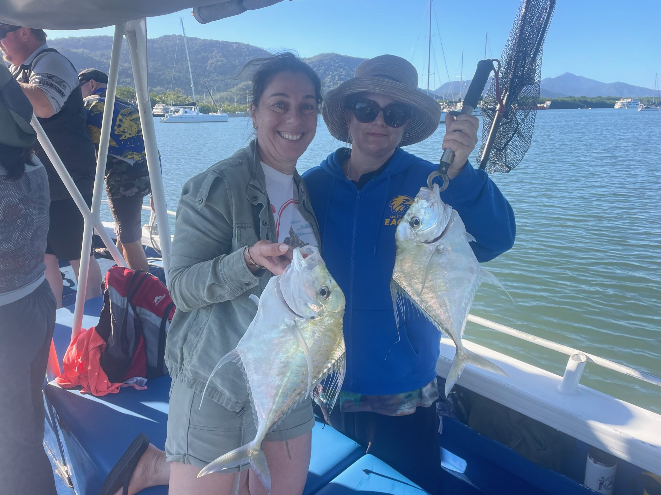 Two very happy customers showing us there catches of Diamond Trevally while estuary fishing in Trinity Inlet, Cairns!